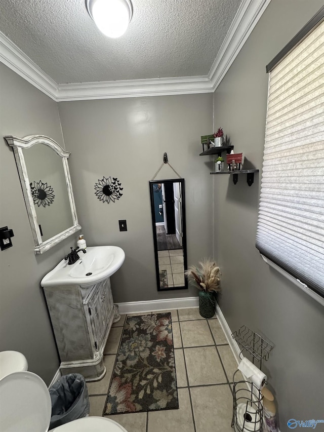 half bath with toilet, a textured ceiling, vanity, and crown molding
