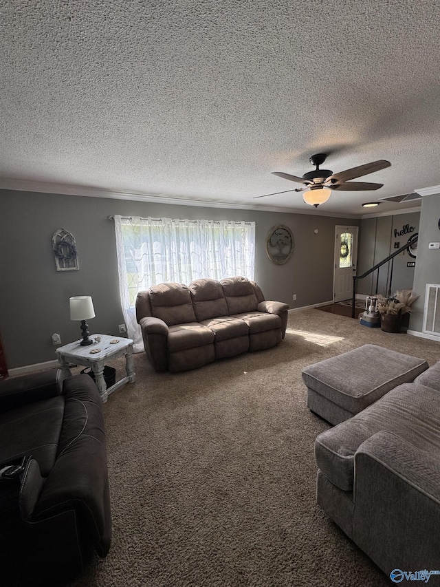 living area with baseboards, a textured ceiling, visible vents, ceiling fan, and carpet