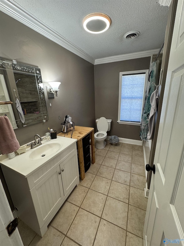bathroom with vanity, a textured ceiling, crown molding, toilet, and visible vents