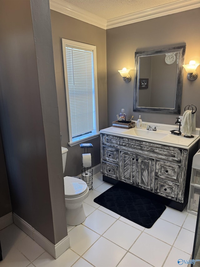 half bathroom featuring vanity, baseboards, tile patterned floors, crown molding, and toilet