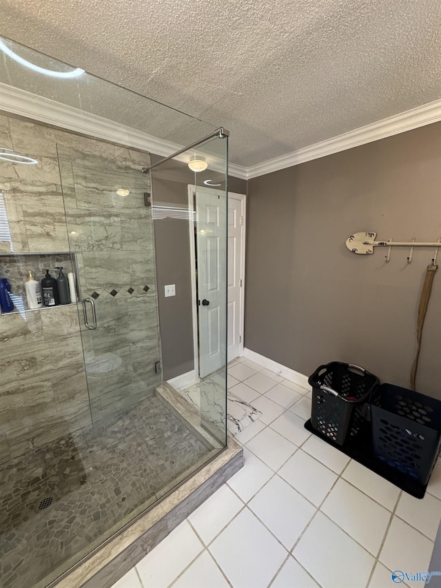 bathroom with ornamental molding, a stall shower, tile patterned flooring, and a textured ceiling