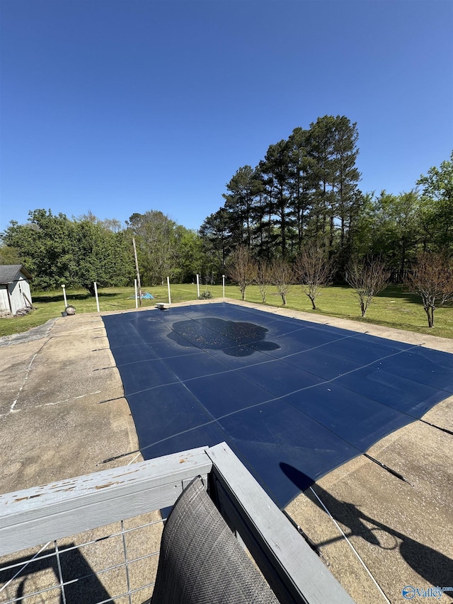 view of pool featuring a yard and an outdoor structure