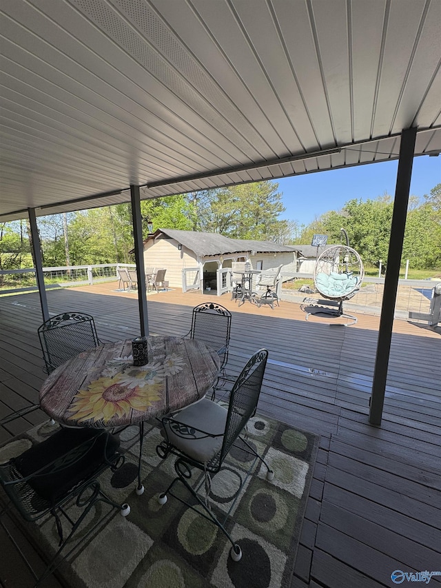 wooden deck featuring outdoor dining area