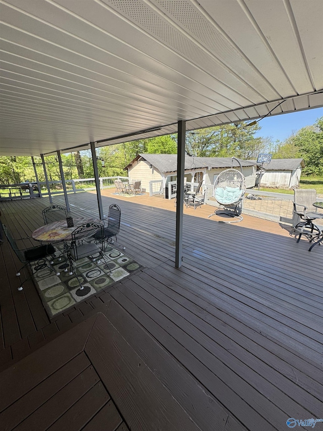 wooden terrace with outdoor dining area