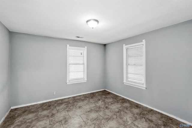 empty room featuring visible vents and baseboards