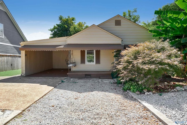 view of front of property with an attached carport, a porch, driveway, and crawl space