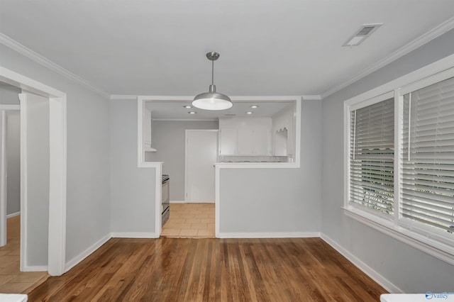 unfurnished dining area with visible vents, baseboards, and ornamental molding