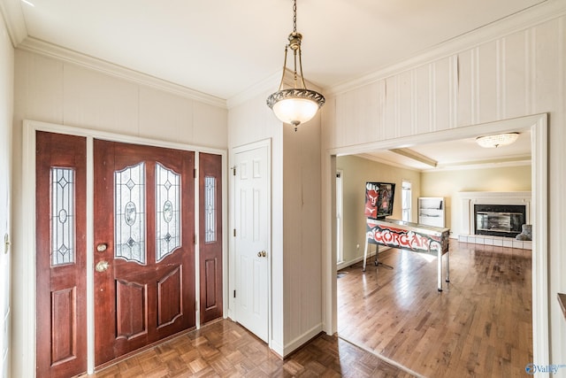 entrance foyer with parquet flooring and ornamental molding