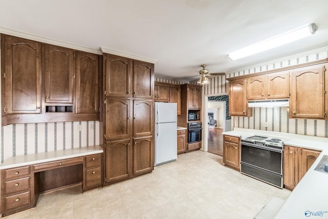 kitchen featuring ceiling fan, built in desk, and black appliances