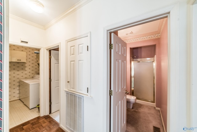 hall with washer / clothes dryer, dark parquet flooring, and ornamental molding