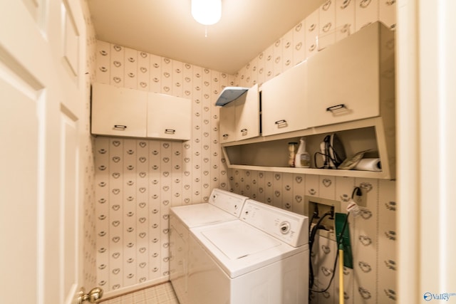 washroom featuring cabinets and separate washer and dryer