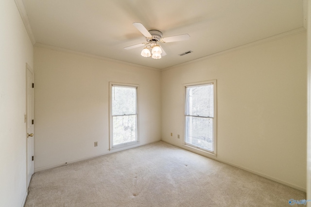 carpeted empty room featuring ceiling fan and ornamental molding