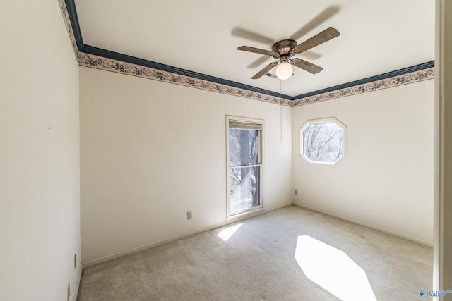 carpeted empty room featuring crown molding and ceiling fan