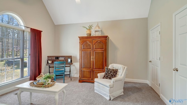 sitting room featuring lofted ceiling, carpet, and baseboards