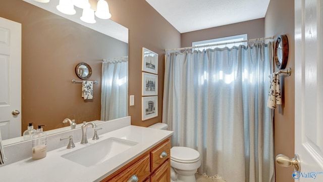 bathroom with a shower with curtain, toilet, and vanity