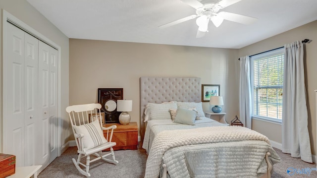 bedroom with ceiling fan, light colored carpet, a closet, and baseboards