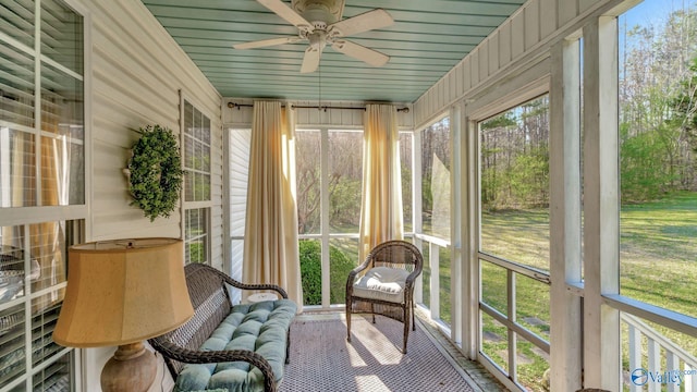 unfurnished sunroom with ceiling fan