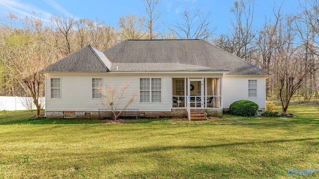 back of house with crawl space, a shingled roof, a yard, and a sunroom