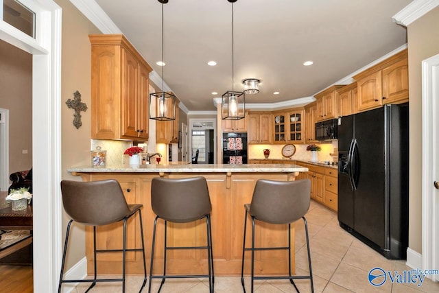 kitchen with kitchen peninsula, black appliances, ornamental molding, light tile patterned floors, and a kitchen breakfast bar