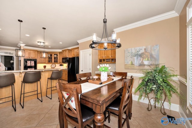 tiled dining room with a notable chandelier and ornamental molding