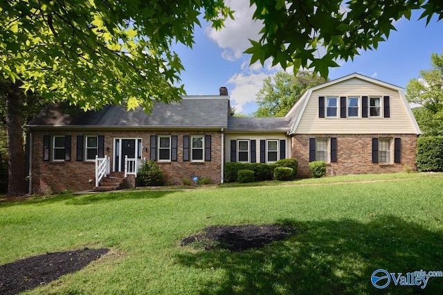 2614 Vista Dr SE, Huntsville, AL 35803 - view of front of home with brick siding, a front lawn, a chimney, and a gambrel roof