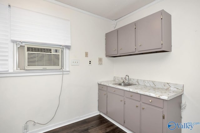 2614 Vista Dr SE, Huntsville, AL 35803 - washroom featuring a sink, ornamental molding, baseboards, dark wood-type flooring, and cooling unit