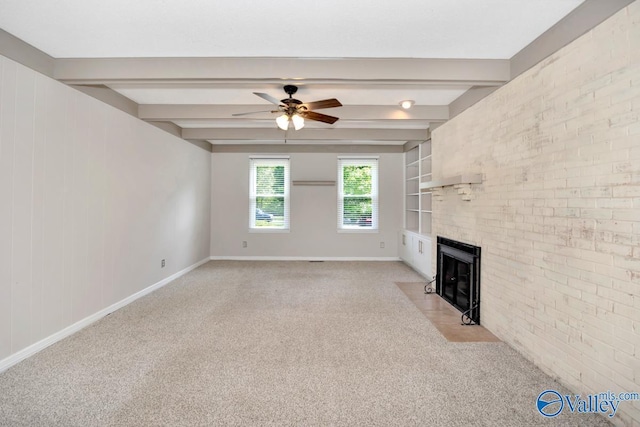 2614 Vista Dr SE, Huntsville, AL 35803 - unfurnished living room featuring light colored carpet, baseboards, a ceiling fan, beamed ceiling, and a fireplace with flush hearth