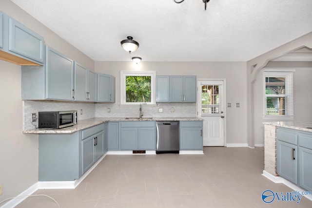 2614 Vista Dr SE, Huntsville, AL 35803 - kitchen with appliances with stainless steel finishes, tasteful backsplash, a sink, light stone countertops, and baseboards