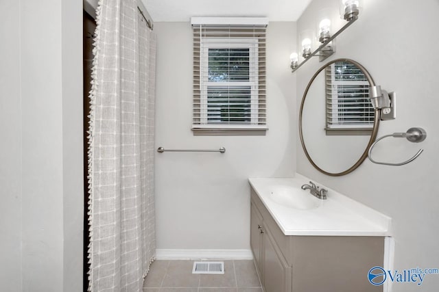 2614 Vista Dr SE, Huntsville, AL 35803 - bathroom featuring vanity, baseboards, tile patterned flooring, and plenty of natural light