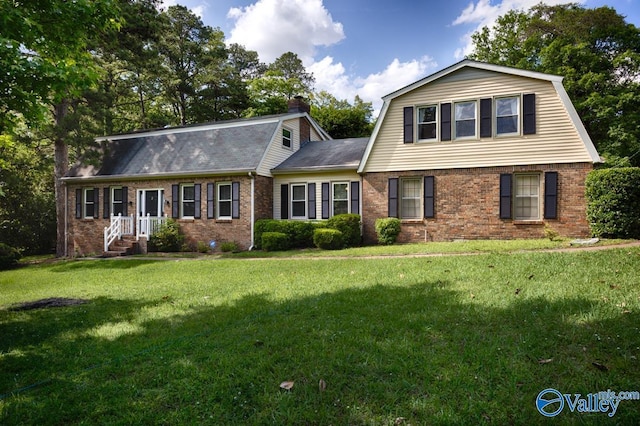 2614 Vista Dr SE, Huntsville, AL 35803 - dutch colonial featuring a gambrel roof, brick siding, a front lawn, a shingled roof, and a chimney