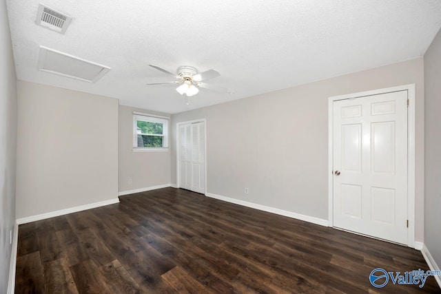 2614 Vista Dr SE, Huntsville, AL 35803 - unfurnished room featuring attic access, dark wood-type flooring, baseboards, ceiling fan, and a textured ceiling