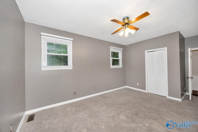 2614 Vista Dr SE, Huntsville, AL 35803 - unfurnished bedroom featuring carpet, multiple windows, and baseboards