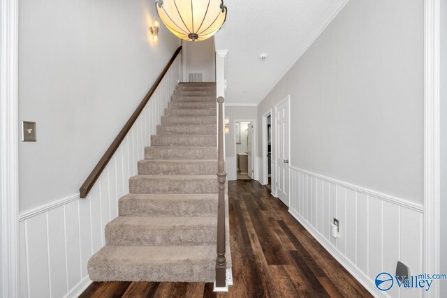 2614 Vista Dr SE, Huntsville, AL 35803 - stairway featuring wood finished floors, ornamental molding, and a wainscoted wall