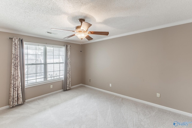 spare room with light colored carpet, crown molding, and visible vents