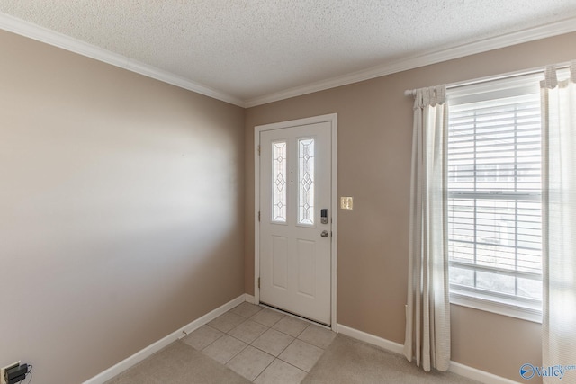 foyer featuring baseboards, a textured ceiling, and light colored carpet