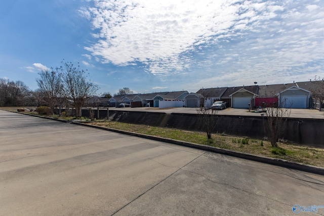 view of road featuring a residential view and curbs