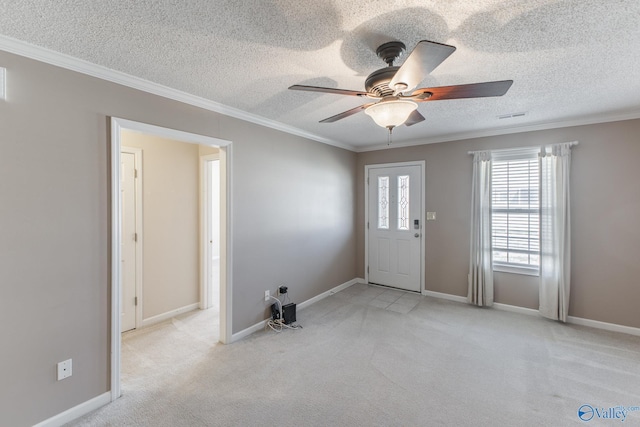 entryway featuring light carpet, a textured ceiling, and crown molding