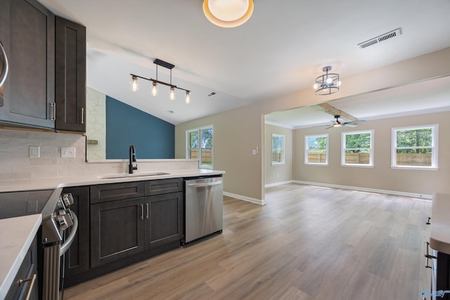 12034 Runningmeade Trl SE, Huntsville, AL 35803 - kitchen with stainless steel appliances, a sink, open floor plan, a peninsula, and ceiling fan