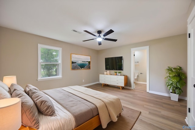 12034 Runningmeade Trl SE, Huntsville, AL 35803 - bedroom featuring light wood-type flooring, baseboards, connected bathroom, and a ceiling fan
