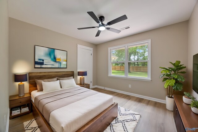 12034 Runningmeade Trl SE, Huntsville, AL 35803 - bedroom with light wood-style floors, baseboards, and a ceiling fan