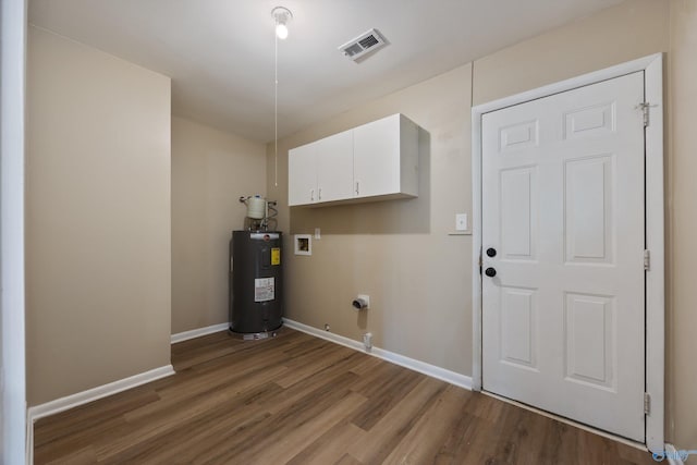 12034 Runningmeade Trl SE, Huntsville, AL 35803 - laundry area with water heater, cabinet space, wood finished floors, baseboards, and hookup for a washing machine