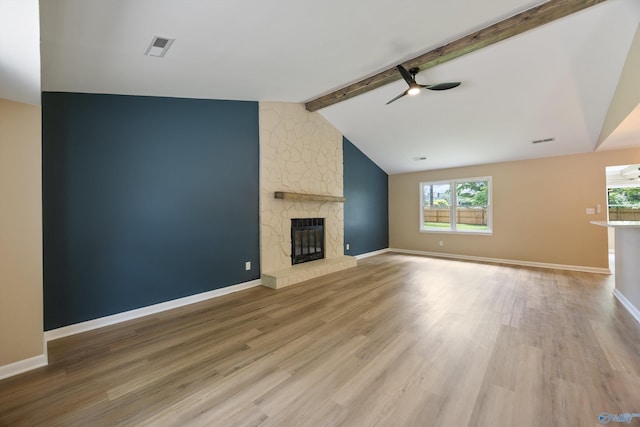 12034 Runningmeade Trl SE, Huntsville, AL 35803 - unfurnished living room featuring ceiling fan, plenty of natural light, a stone fireplace, and light wood-type flooring