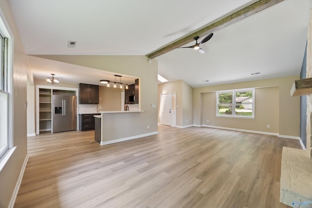 12034 Runningmeade Trl SE, Huntsville, AL 35803 - unfurnished living room featuring light wood-style floors, a ceiling fan, baseboards, a stone fireplace, and a chandelier