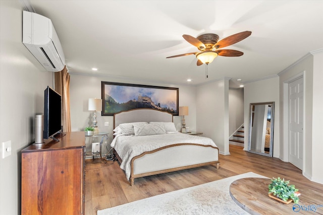 bedroom featuring a wall mounted air conditioner, light hardwood / wood-style flooring, ceiling fan, and crown molding