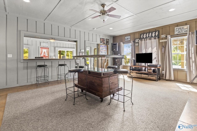 sunroom / solarium featuring ceiling fan