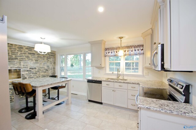 kitchen with white cabinetry, appliances with stainless steel finishes, sink, and hanging light fixtures