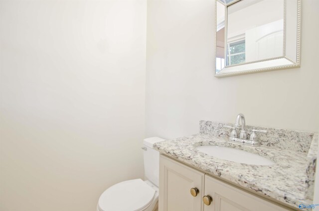 bathroom featuring toilet and vanity