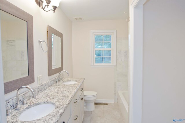 bathroom with vanity, toilet, and tile patterned floors