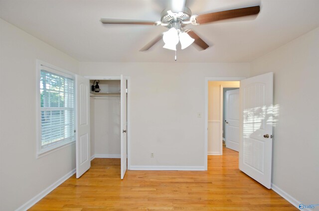 unfurnished bedroom featuring light hardwood / wood-style floors, a closet, and ceiling fan