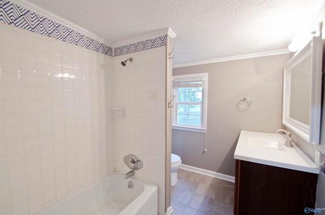 full bathroom with vanity, crown molding, tiled shower / bath combo, and toilet